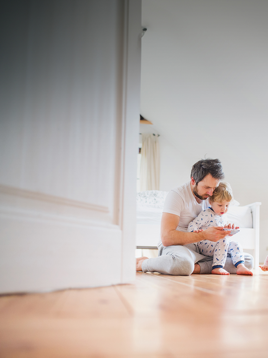 Couple rolling out area rug on new Hardwood Floor